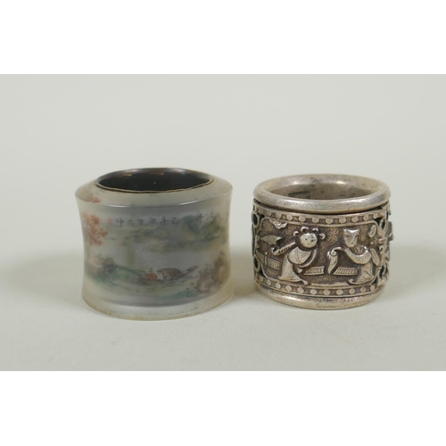 617 - A Chinese reverse painted glass archers thumb ring decorated withe a riverside landscape, and a whit... 