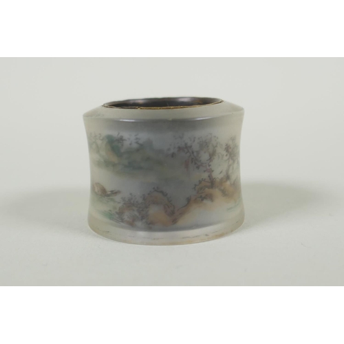 617 - A Chinese reverse painted glass archers thumb ring decorated withe a riverside landscape, and a whit... 