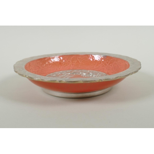 63 - A Chinese salmon pink and silver glazed porcelain dish with lobed rim, with raised deer and crane de... 