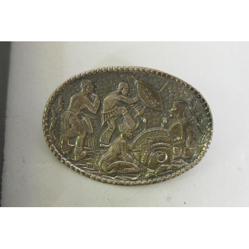 630 - A Candida South African silver brooch decorated with warriors dancing, 53mm long, and a vintage diam... 