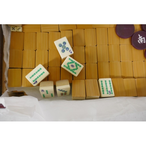 8 - A vintage Mah-Jong set with bamboo and ivorine tiles, and four lacquered counter trays, 41cm long