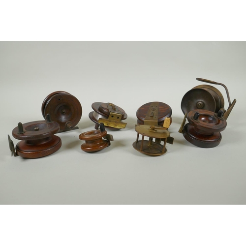 82 - Eight antique wood and brass fly fishing reels