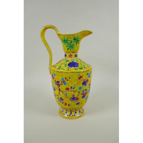 85 - A Chinese yellow ground porcelain fahua ewer decorated with prunus blossom and cypress trees, 32cm h... 