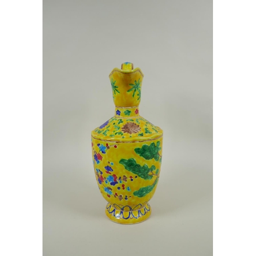 85 - A Chinese yellow ground porcelain fahua ewer decorated with prunus blossom and cypress trees, 32cm h... 