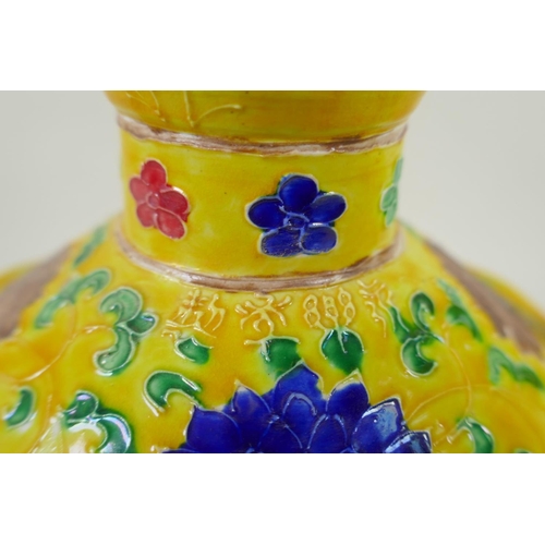 85 - A Chinese yellow ground porcelain fahua ewer decorated with prunus blossom and cypress trees, 32cm h... 