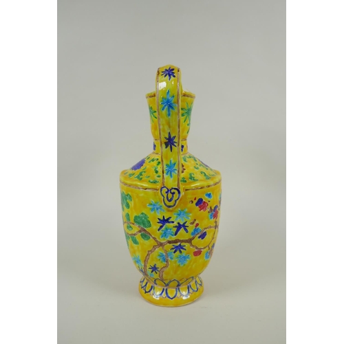 85 - A Chinese yellow ground porcelain fahua ewer decorated with prunus blossom and cypress trees, 32cm h... 