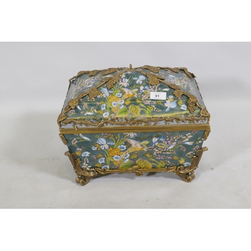 91 - A porcelain casket decorated with exotic birds and brass mounts with grape and vine detail, 37 x 27 ... 