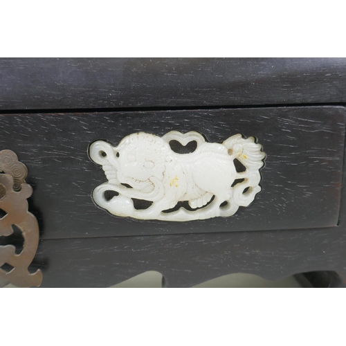 93 - A Chinese hardwood box with secret locked drawer, set with carved jade lions, 26 x 9cm