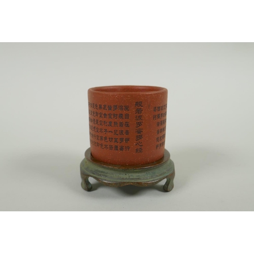 95 - A Chinese YiXing cylinder cup on a bronze stand, decorated with allover character inscription, 6cm d... 