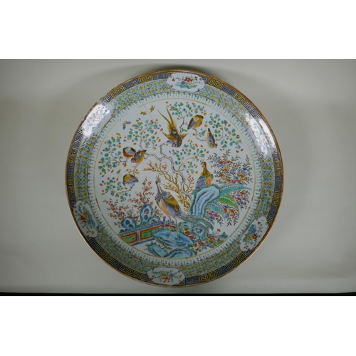 334 - An C18th/C19th Chinese famille verte porcelain charger decorated with peacocks and asiatic birds per... 