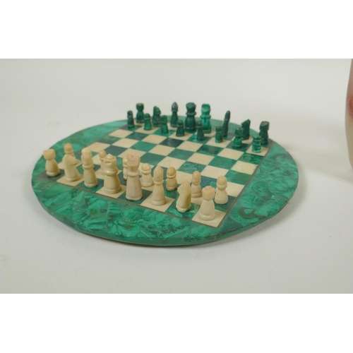 102 - A malachite and alabaster chess set, and an African carved soapstone abstract figure, 29cm high