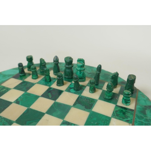 102 - A malachite and alabaster chess set, and an African carved soapstone abstract figure, 29cm high