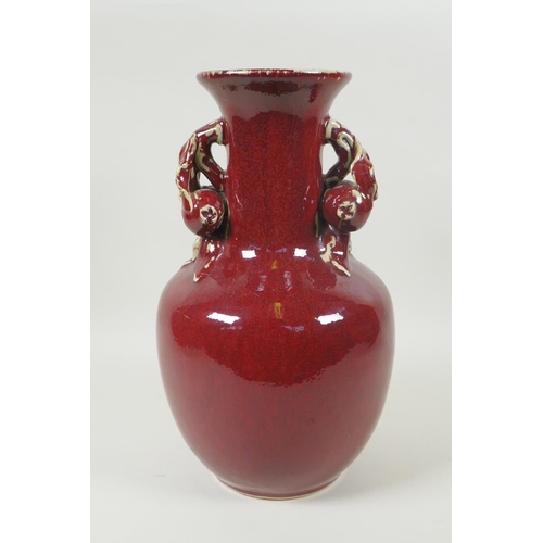 103 - A Chinese flambe glazed pottery vase, the two handles in the form of pomegranates, 30cm high