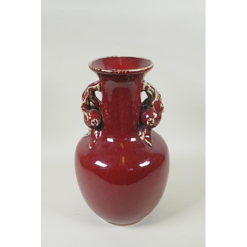 103 - A Chinese flambe glazed pottery vase, the two handles in the form of pomegranates, 30cm high