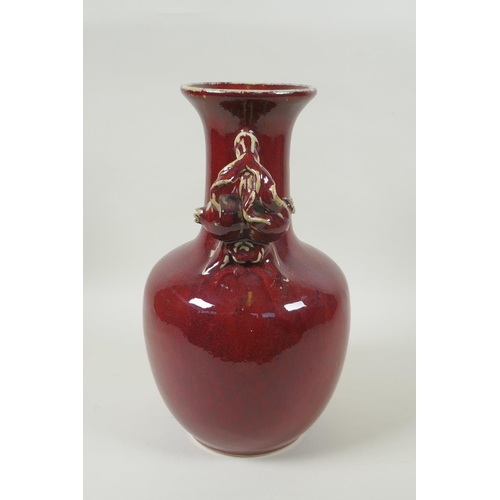 103 - A Chinese flambe glazed pottery vase, the two handles in the form of pomegranates, 30cm high