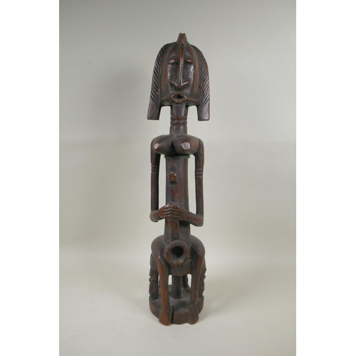 104 - A west African Dogon peoples carved hardwood Bombou Toro figure, 58cm high