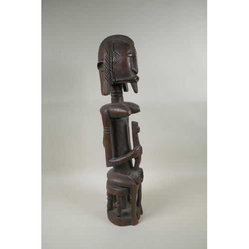 104 - A west African Dogon peoples carved hardwood Bombou Toro figure, 58cm high