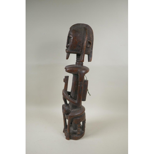 104 - A west African Dogon peoples carved hardwood Bombou Toro figure, 58cm high