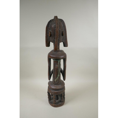 104 - A west African Dogon peoples carved hardwood Bombou Toro figure, 58cm high