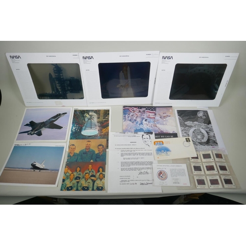 105 - A quantity of NASA collectables, to include press photographs, transparencies, slides, booklets, aut... 