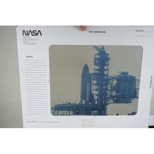 105 - A quantity of NASA collectables, to include press photographs, transparencies, slides, booklets, aut... 