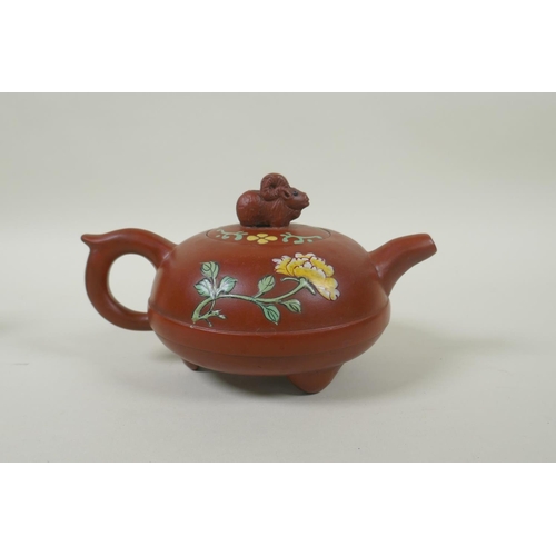 108 - A Chinese YiXing teapot of squat form with a ram shaped knop and enamelled floral decoration, 12cm d... 