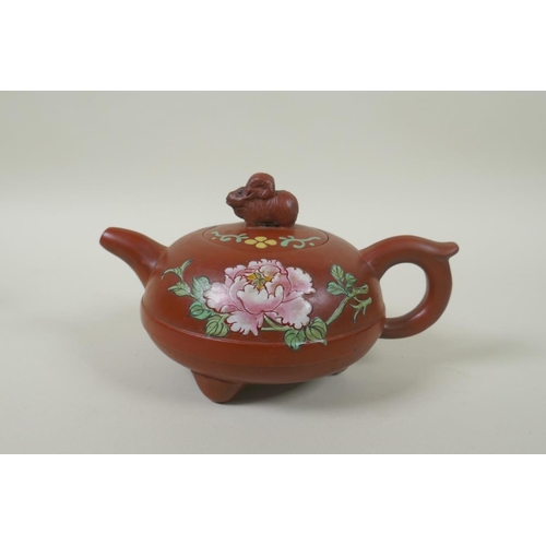 108 - A Chinese YiXing teapot of squat form with a ram shaped knop and enamelled floral decoration, 12cm d... 