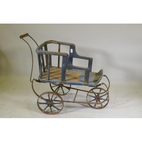 1082 - A Victorian painted pine and wrought iron pram, 80cm high x 90cm long