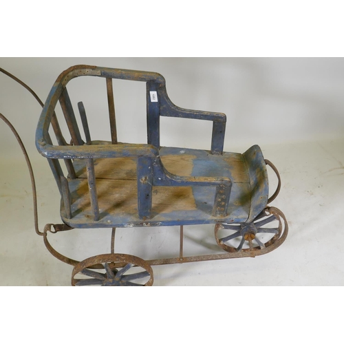 1082 - A Victorian painted pine and wrought iron pram, 80cm high x 90cm long