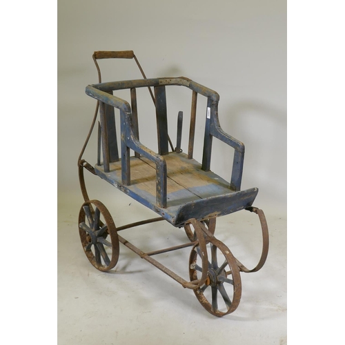 1082 - A Victorian painted pine and wrought iron pram, 80cm high x 90cm long