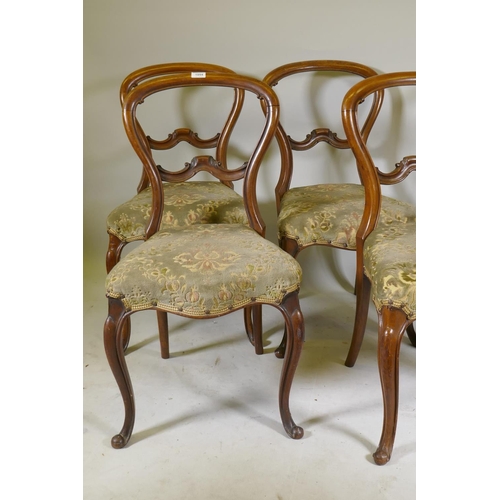 1094 - A set of five Victorian walnut balloon back dining chairs with carved backs, raised on cabriole supp... 