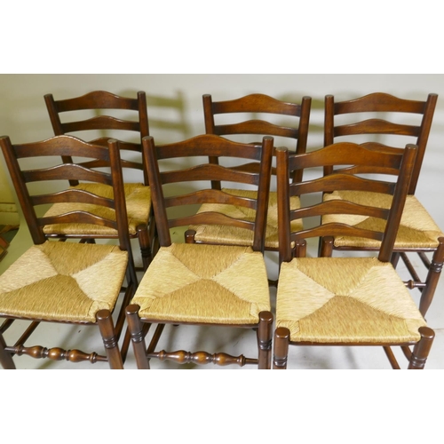 1095 - A set of six ash ladderback chairs with drop in rush seats