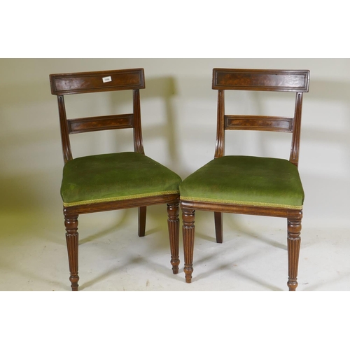 1096 - A pair of George III mahogany side chairs with panelled bar backs and moulded rails, raised on reede... 