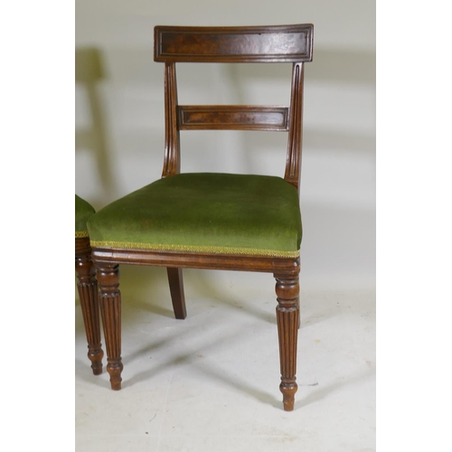 1096 - A pair of George III mahogany side chairs with panelled bar backs and moulded rails, raised on reede... 