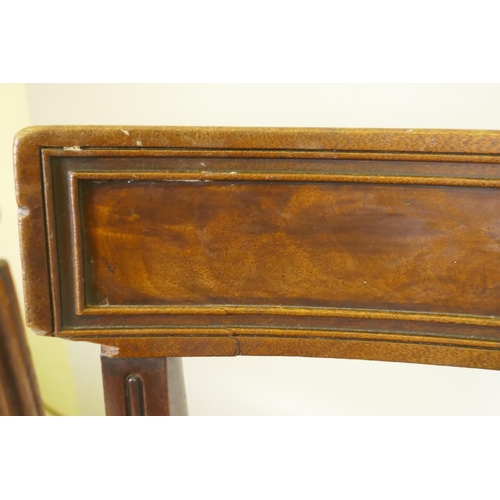 1096 - A pair of George III mahogany side chairs with panelled bar backs and moulded rails, raised on reede... 