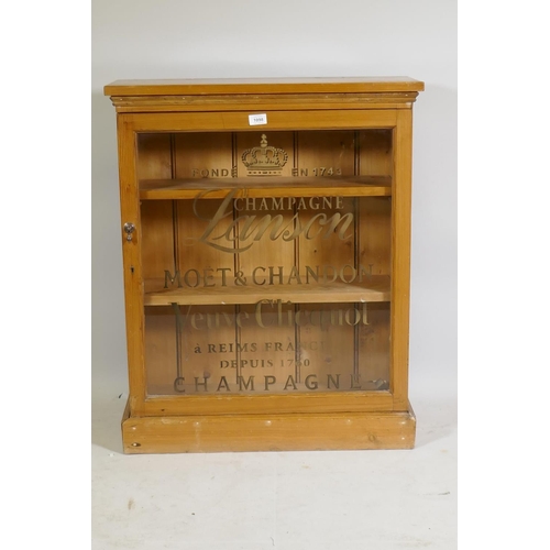 1098 - A C19th pine side cabinet with single glazed door and later gilt decoration, raised on a plinth base... 