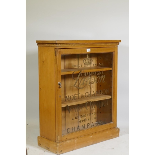 1098 - A C19th pine side cabinet with single glazed door and later gilt decoration, raised on a plinth base... 