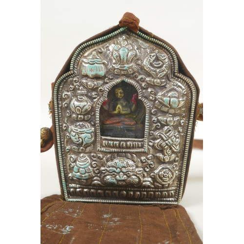 110 - A Tibetan gau box in a silk carry bag, 10 x 13cm