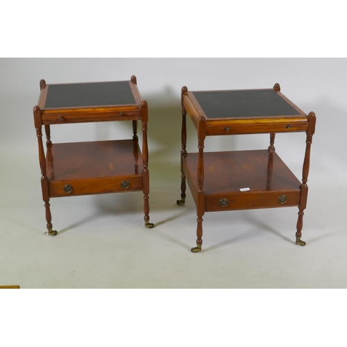 1111 - A pair of yew wood two tier side tables with inset tops over a pull out slide and single drawer, rai... 