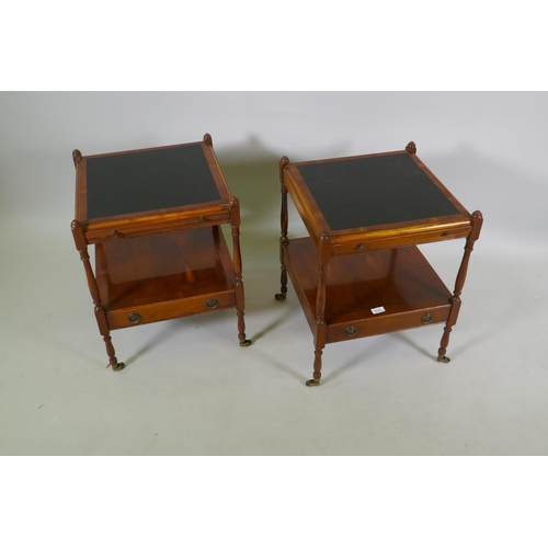 1111 - A pair of yew wood two tier side tables with inset tops over a pull out slide and single drawer, rai... 