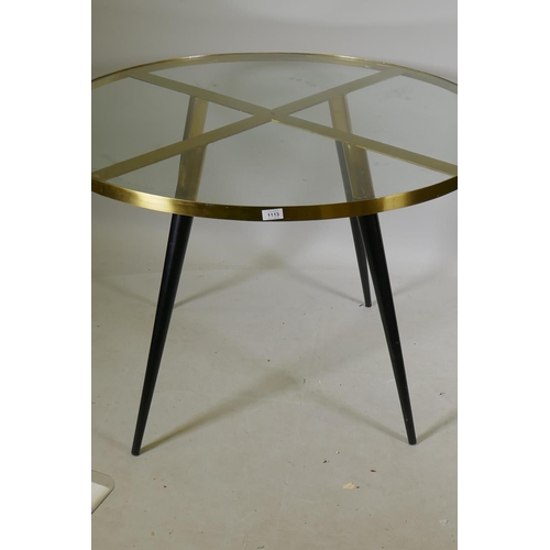 1113 - A Swoon 'Eros' polished brass four seater dining table with glass top, 110cm diameter, 75cm high