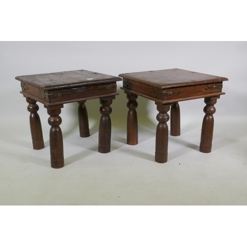 1122 - A pair of vintage Indian teak side tables with metal mounts, raised on turned supports, 46 x 46 x 46... 