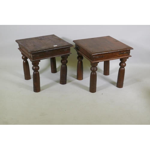 1122 - A pair of vintage Indian teak side tables with metal mounts, raised on turned supports, 46 x 46 x 46... 