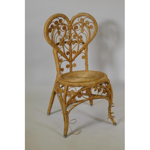 1124 - A vintage bamboo cane chair with heart shaped back