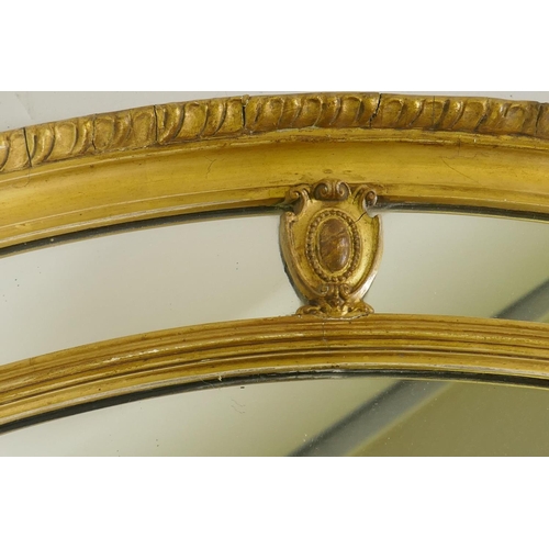 1129 - An early C20th oval sectional giltwood and plaster wall mirror, AF, 87 x 67cm