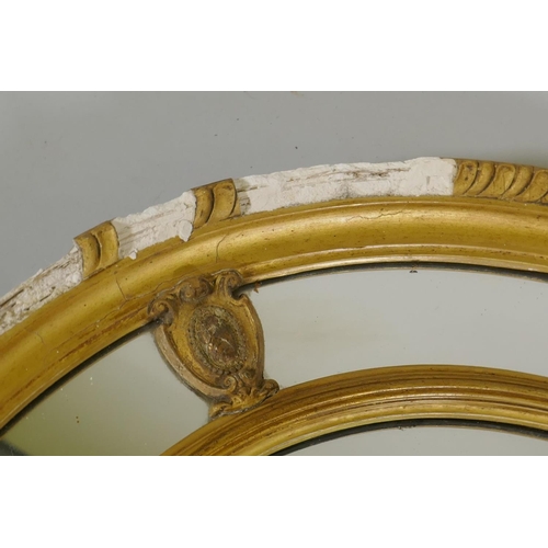 1129 - An early C20th oval sectional giltwood and plaster wall mirror, AF, 87 x 67cm