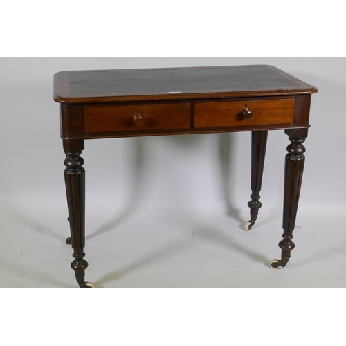 1130 - An early C19th mahogany two drawer writing table with inset faux leather top, raised on reeded suppo... 