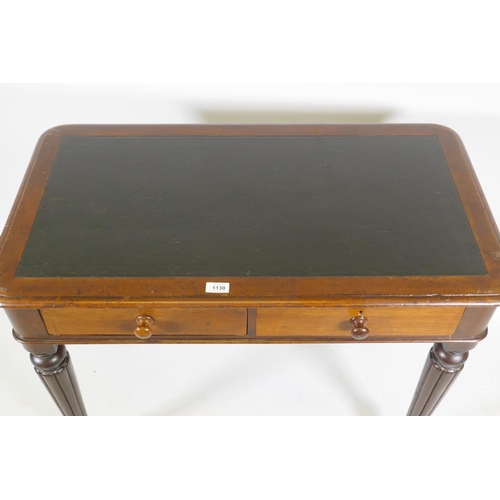 1130 - An early C19th mahogany two drawer writing table with inset faux leather top, raised on reeded suppo... 