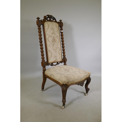 1142 - A Victorian carved walnut high back side chair, with carved crest back and shaped front, raised on c... 