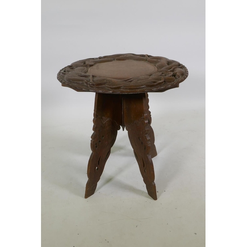 1143 - A C19th colonial carved hardwood occasional table with dragon decoration, 51cm high x 51cm diameter